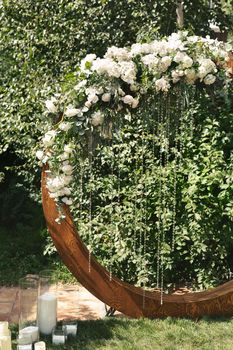 circle wedding arch with flower petals and candles.