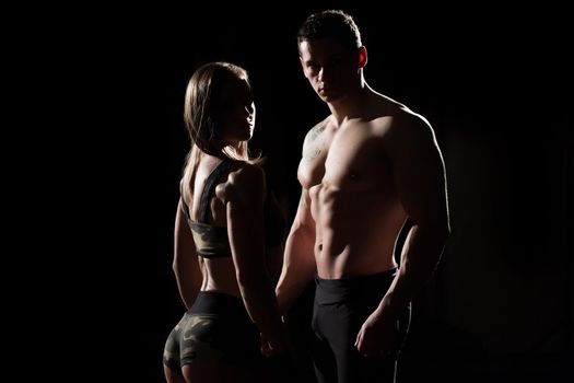 Sports man and woman. Silhouettes on a black background
