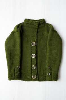 Knitted children's sweater on a white background.