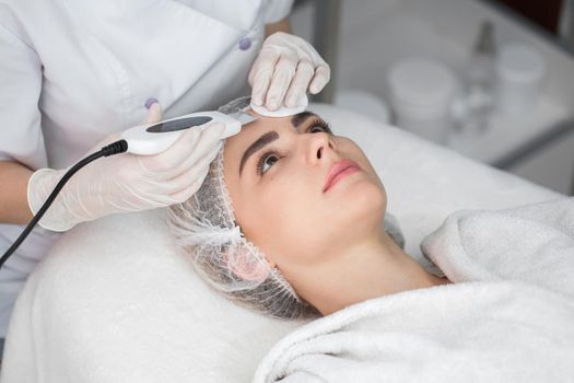 Skin Care. Close-up Of Beautiful Woman Receiving Ultrasound Cavitation Facial Peeling. Ultrasonic Skin Cleansing Procedure. Beauty Treatment. Cosmetology. Beauty Spa Salon