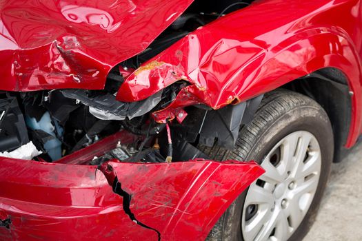 Red Car crash background. Front of red car get damaged by accident on the road.