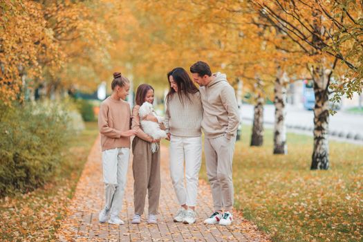 Portrait of happy family of four in autumn
