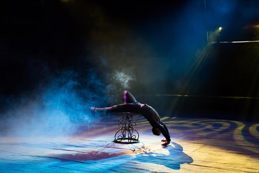 Acrobat performs a difficult trick in the circus