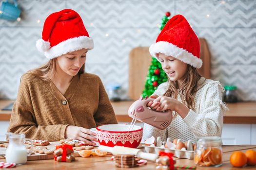 Little girls preparing Christmas gingerbread at home