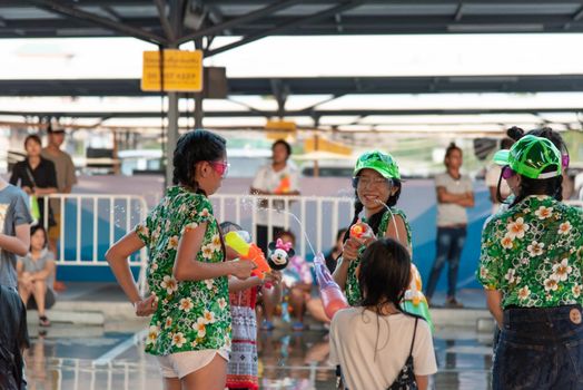 Bangkok, Thailand - April 15, 2017 : Unidentified women play and enjoying splashing with waters gun in Songkran Festival.