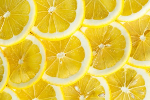 A slices of fresh yellow lemon texture background pattern.