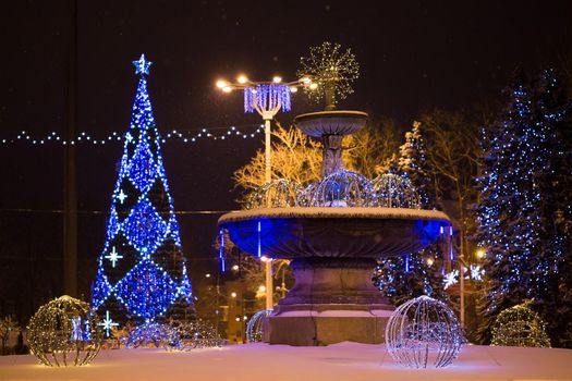 Christmas tree on the main Square on a winter night in snow.