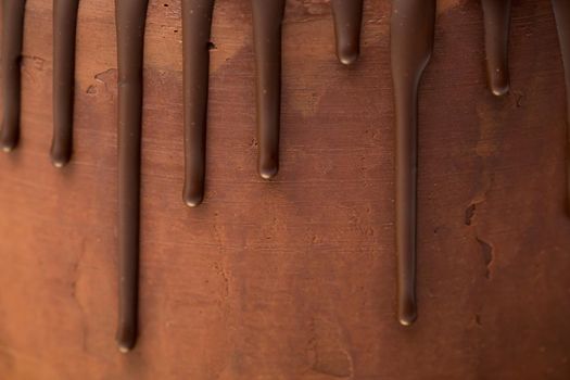 chocolate drips on the background of dark chocolate ganache.