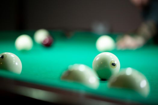 Billiard balls in a green pool table.