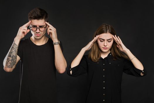 Man and woman feeling stressed and angry at each other, frustrated couple hands on head, not talking after dispute, teenagers quarrel, family crisis and relationships problems.