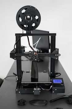 Electronic three dimensional plastic 3D printer during work in laboratory.