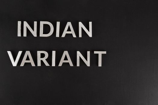 words indian variant laid with silver metal letters on flat matte black surface