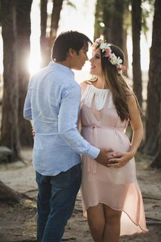 Young attractive couple: pregnant mother and happy father.