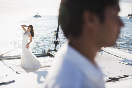 Just married couple on yacht. Happy bride and groom.