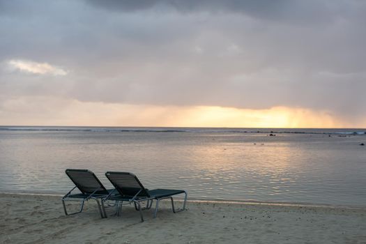 beach chair on the beach with sunset.