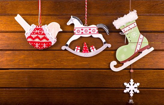 The Christmas decoration toys over wooden background.