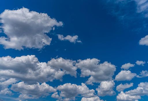 Clouds and deep blue sky background with text space