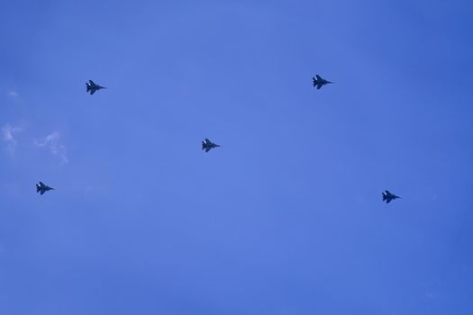 Parade of military aircrafts in the sky.