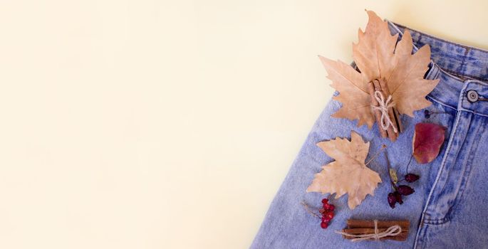 maple leaf in jeans pocket. denim in autumn composicion. Flat lay. Top view.