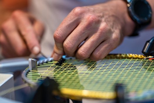 manual stringing of a badminton racket in service