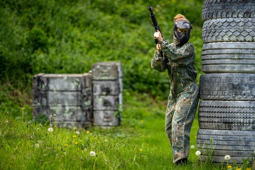 young woman in action while playing paintball