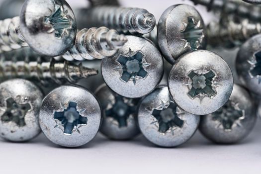 Close up of a pile of multipurpose metal screw heads