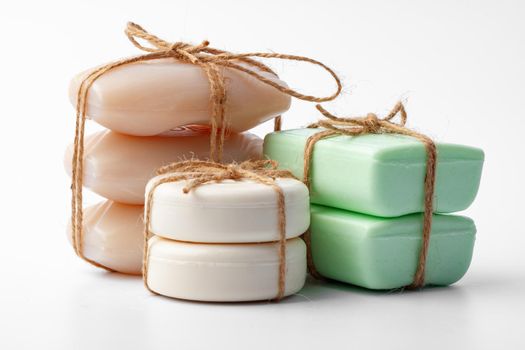 Beige and green soap bars on white background