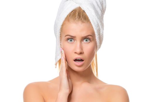 Young woman in towel amazement looking at the camera. Closeup