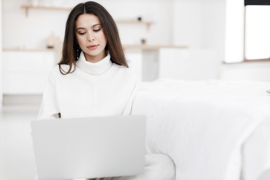 young cozy woman working in laptop