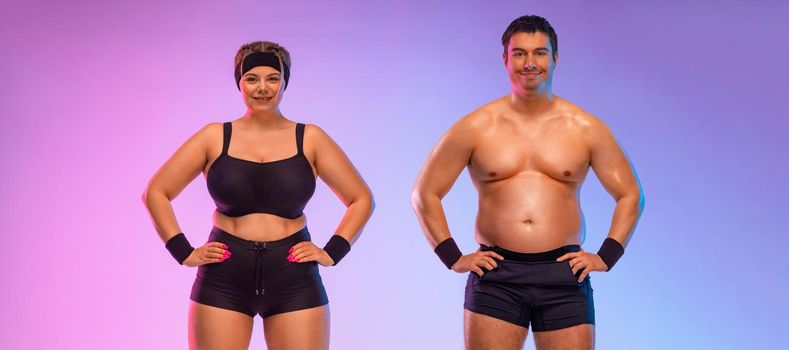 Fat man and woman in gym. Body positive and fitness concept.