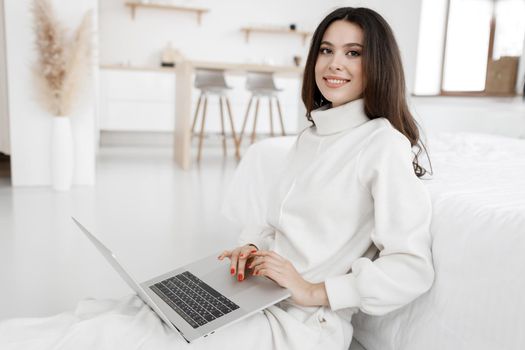 young cozy woman working in laptop
