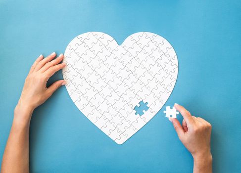 White puzzle in heart shape