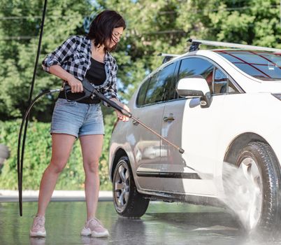 Woman on self service car wash