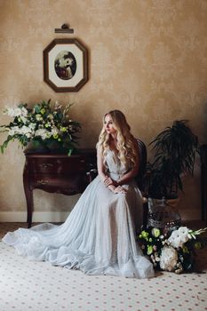 Gorgeous blondie bride in luxury interior in morning.