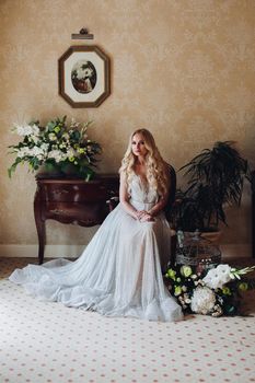 Gorgeous blondie bride in luxury interior in morning.