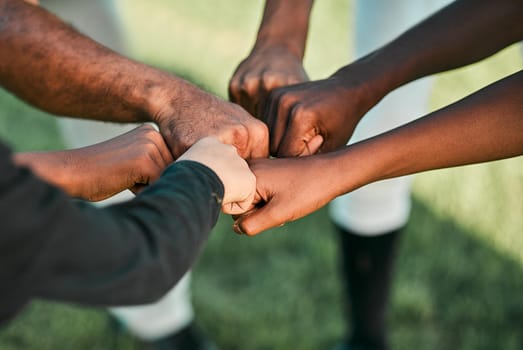 We play to win. Cropped shot of a group of unrecognizable baseball players putting their hands together.