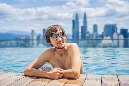 Man relax in swimming pool in sunrise, on rooftop in the city. Rich people