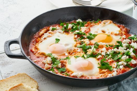 Shakshouka, eggs poached in sauce of tomatoes, olive oil. Mediterranean cuisine.