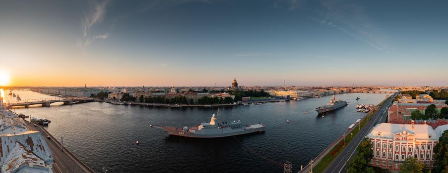 Aerial panoramic landscape of warships in the waters of the Neva River before the holiday of the Russian Navy, sea power, the latest cruisers among the sights, Isaac cathedral on a background