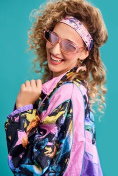 Inspired by the 80s. Studio shot of a beautiful young woman wearing a 80s outfit.