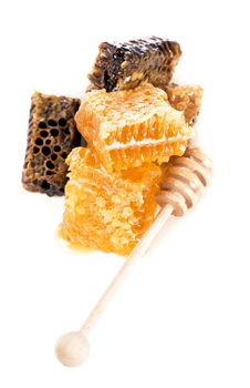 linden and buckwheat honey. Honeycomb with honey dipper isolated on white background