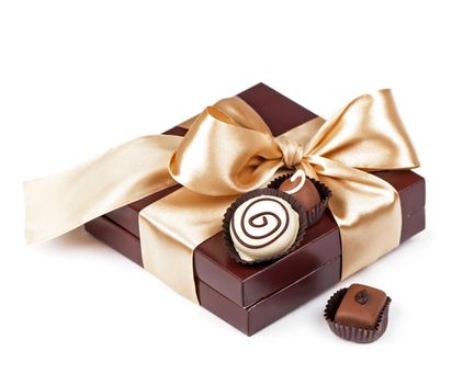 brown box with candies and golden tape