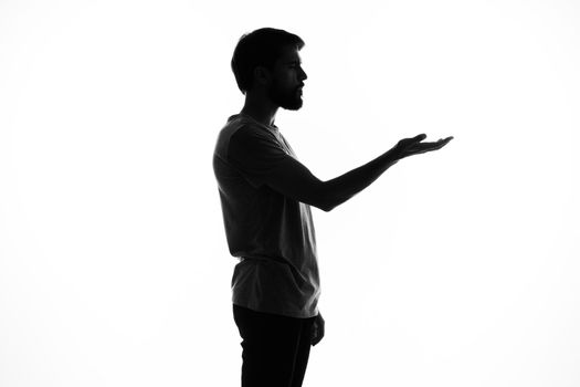 man gesturing with his hands in the shadows posing studio incognito