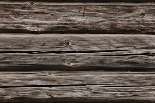 Wooden wall from log as background. Obsolete carpentry boards, panel. Surface of wooden texture for design and decoration. Grey horizontal wood plank grunge texture. Rustic backdrop. Copy space