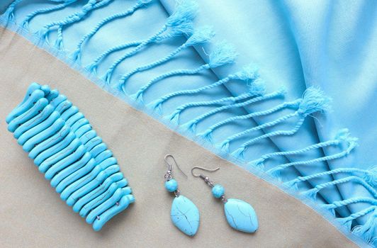 Turquoise bracelet and earrings from natural stone on fringed scarf