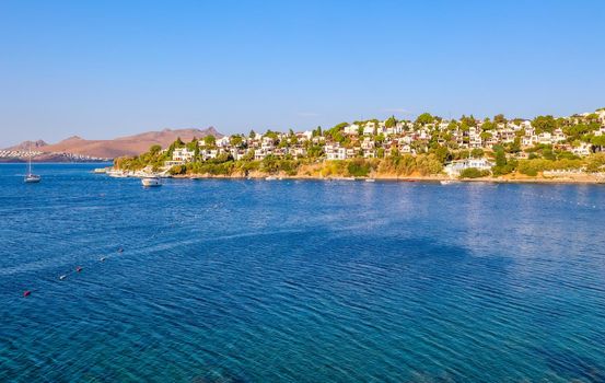 Aegean coast with marvelous blue water, rich nature, islands, mountains and small white houses