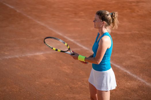 female tennis player on an outdoor clay court