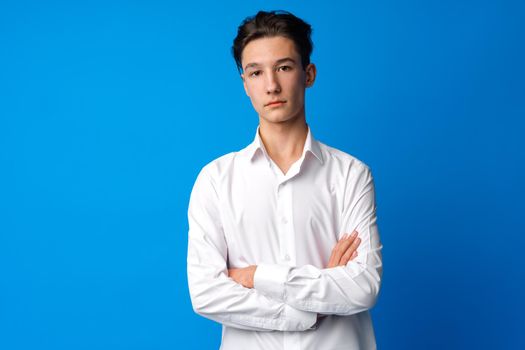 Portrait of teen boy in shirt against blue background