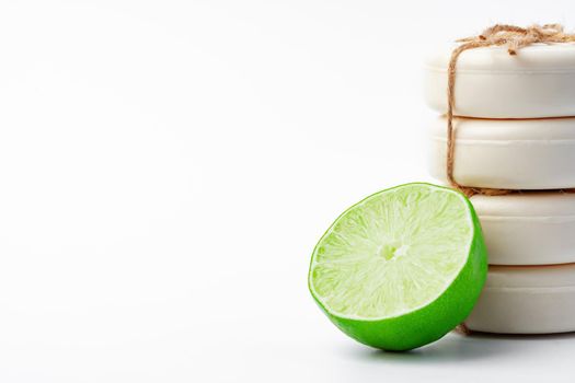 Handmade soap with lime on a white background