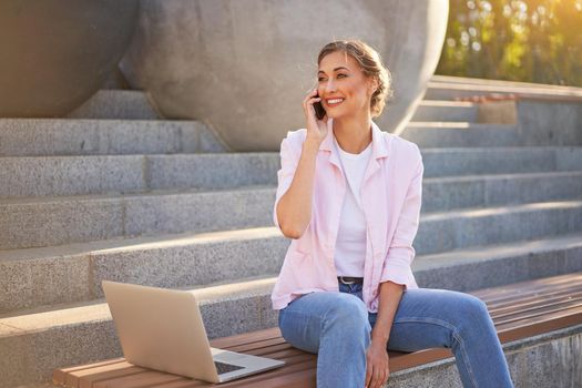 Businesswoman sitting stairs summer park using laptop Business persone working remote. Outdoor